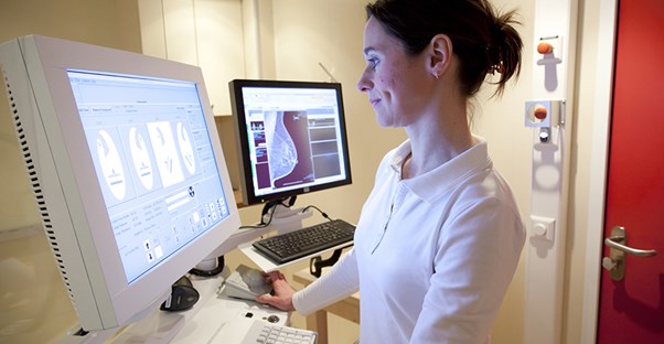 A doctor examines a mammogram