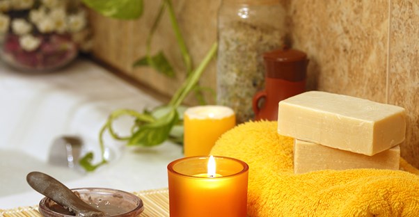 Candles and relaxing ingredients set up for a home spa
