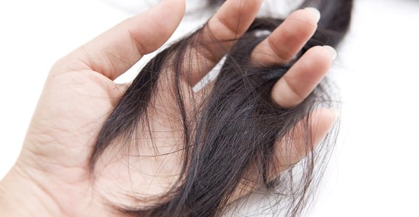 Woman feels how hair loss treatments have restored her hair thickness