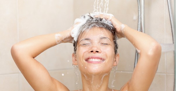 Woman washing her hair with high end shampoo