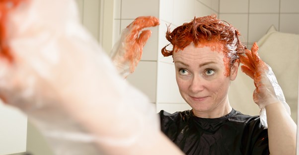 Woman dying her hair at home.