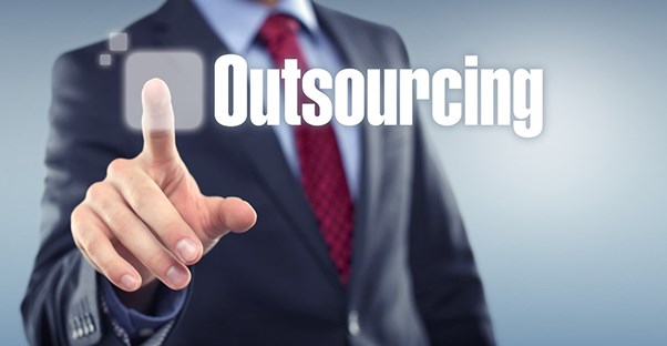 man in suit pointing at word outsourcing