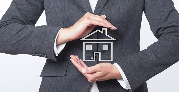 woman holding house symbolizing rental property
