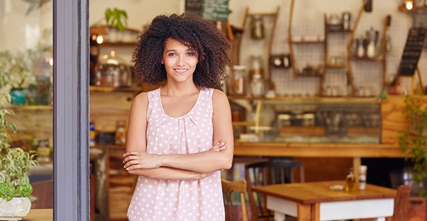 woman standing in front of small business