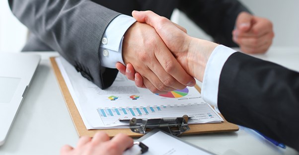 new business owner shaking hands with banker after getting business loan
