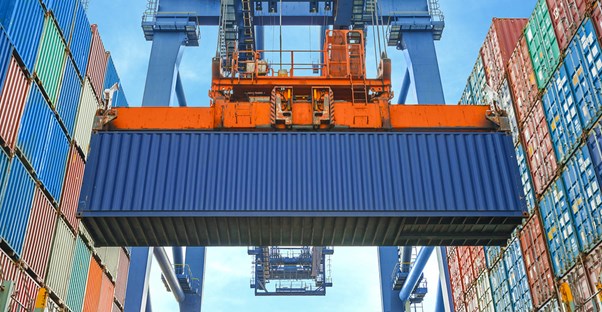 A crane dropping a freight container into place
