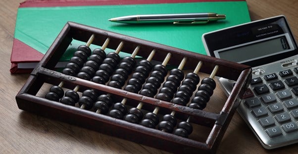 Abacus and a calculator representing merchant accounts