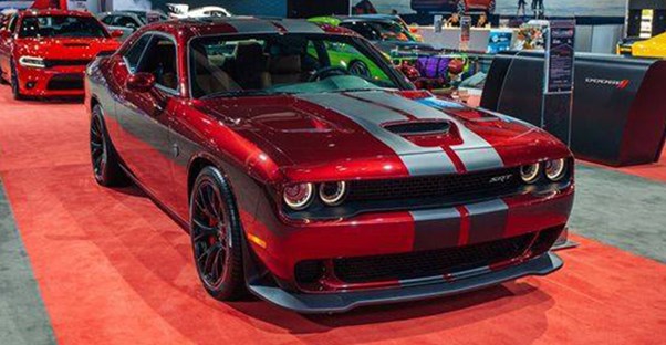 a red ford shelby mustang muscle car with silver racing stripes