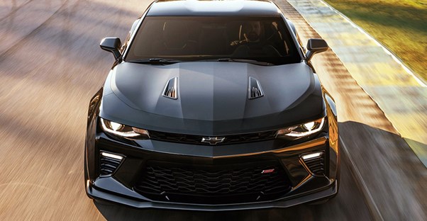 a black 2018 chevrolet camaro driving down the road