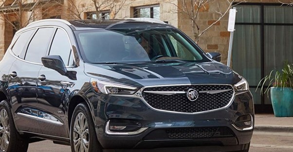 a 2019 buick enclave driving down the street