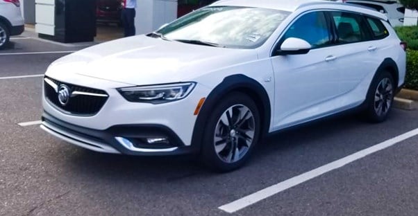 a white 2019 buick regal tourx in a dealership parking lot