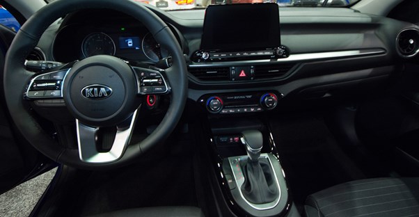 the interior of a 2019 kia forte showing the steering wheel and center console