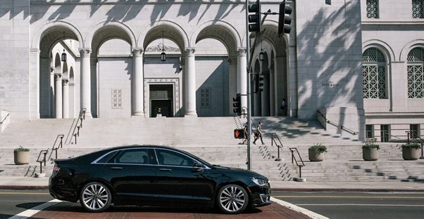 a black 2019 lincoln mkz parked outside of an architectural building