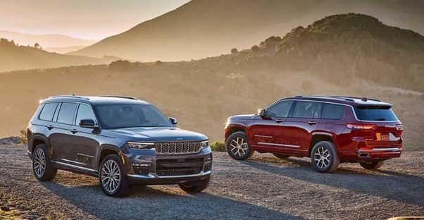 two models of the jeep grand cherokee L one gray and one red