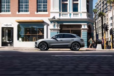 a gray 2021 porsche macan parked along a city street