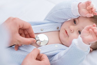 A pediatrician monitors a babys heartbeat