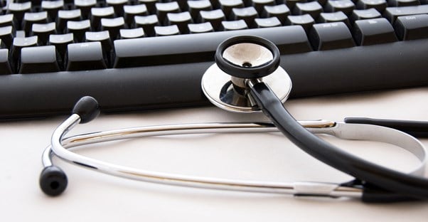 a keyboard sits in the background with a stethoscope resting upon it