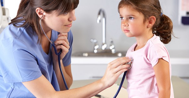 A nurse practitioner checks a little girls heart beat and thinks about how the ability to help others is a job advantage.