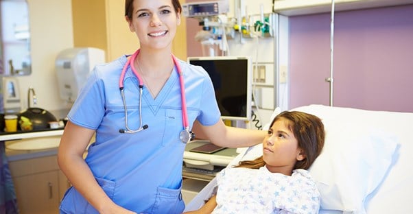 A certified nursing assistant comforts a patient