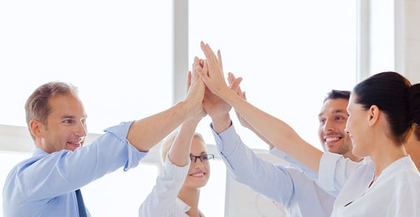 LLC members high five after finishing their operating agreement