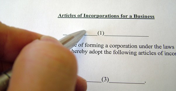 Incorporation paperwork and a pen