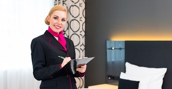 A hospitality manager checks things off of her list