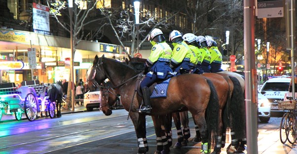 Police officers ride on horses