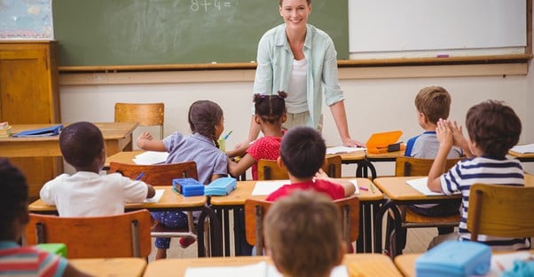 An elementary school teacher talks to her students