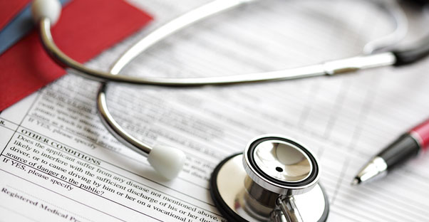 a stethoscope lies on a clip board listing heart disease treatments