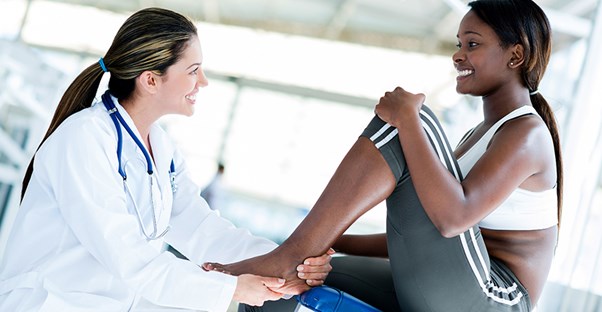 A doctor works with an athlete