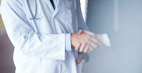 A fecal incontinence doctor shakes hands with a patient