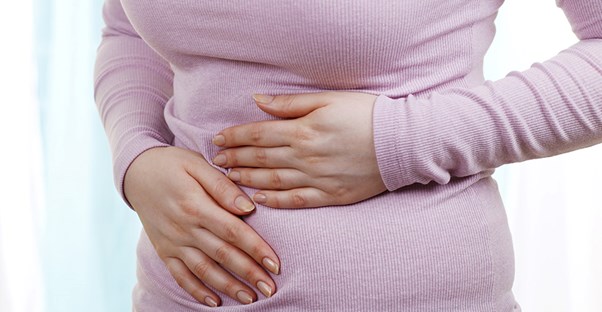 A woman experiences stomach pain