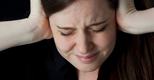 A woman experiences tinnitus