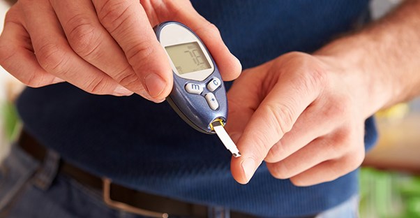 A man tests his blood glucose levels