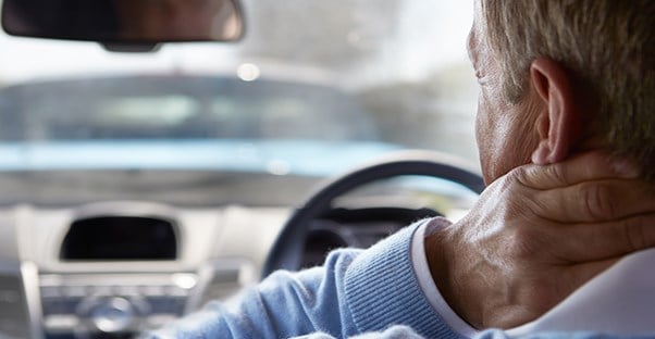 Man driving with neck pain