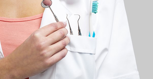dentist holding tools to look at gingivitis symptoms