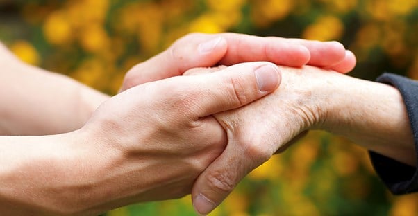 two people holding hands to represent arthritis