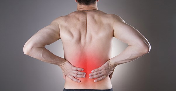 guy holding back because he is experiencing chronic pain