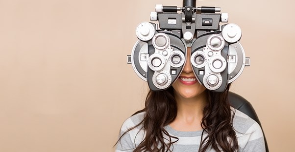 girl at the eye doctor getting vision tested because she is being diagnosed with strabismus