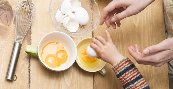 people reaching for raw eggs to represent who is at risk for salmonellosis