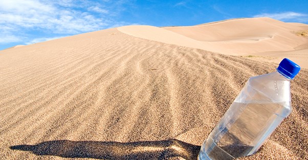 water bottle in the desert to represent dry mouth