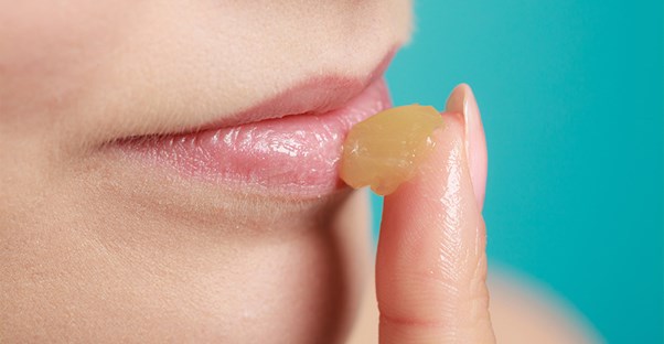 woman treating chapped lips