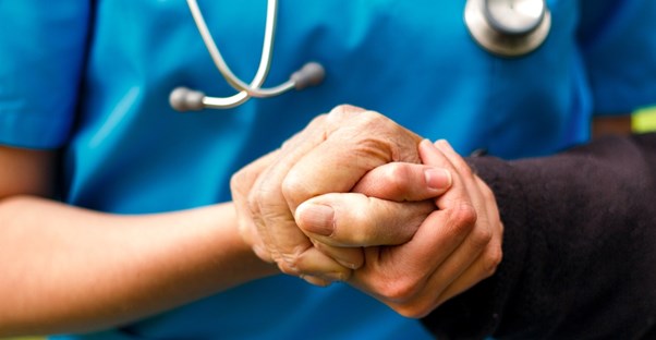 a nurse helps an older patient who has alzheimers