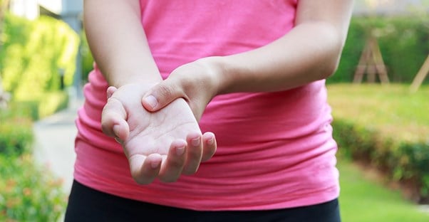 woman holding hand in pain. arthritis.