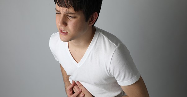 man holding stomach. IBS vs EPI