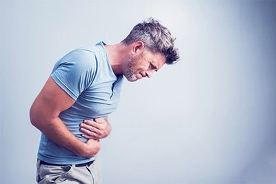 Photo of man holding abdomen