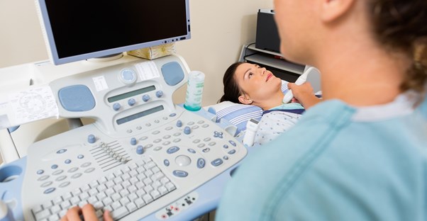 a patient undergoing an ultrasound of the throat and thyroid