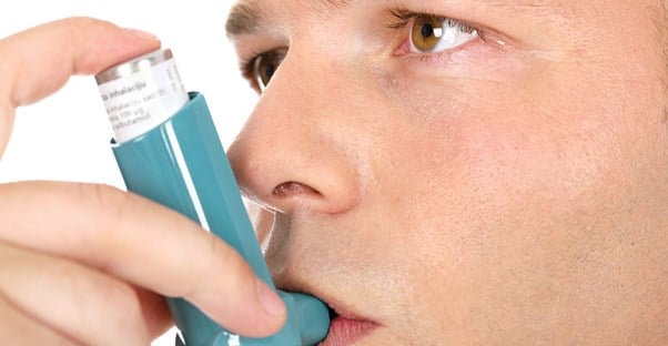 a man uses his new teal inhaler as an asthma treatment