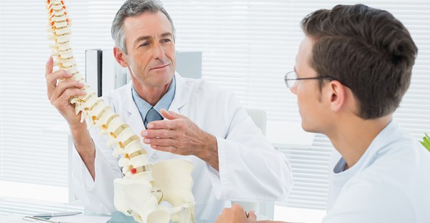 a doctor explaining herniated disc treatments to his patient