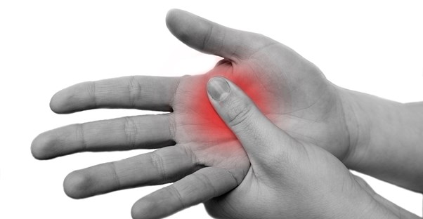 a blank and white hand swells in red pain from osteoarthritis